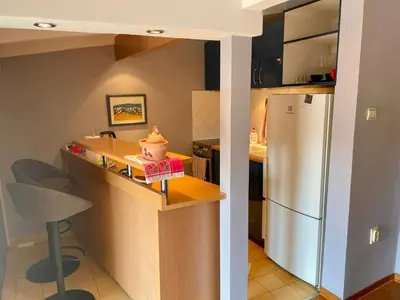 a small kitchen with a refrigerator and a table at Mirabel in Belgrade