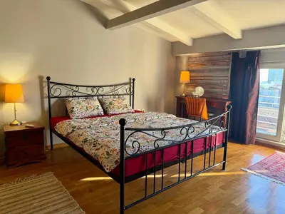 a bedroom with a bed with a black bed frame at Mirabel in Belgrade