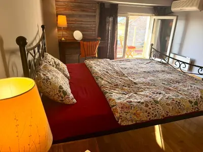 a bedroom with a bed with a red comforter at Mirabel in Belgrade