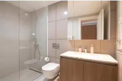 a bathroom with a shower and a toilet and a sink at BW Queen Apartman 412-whit free garage parking in Belgrade