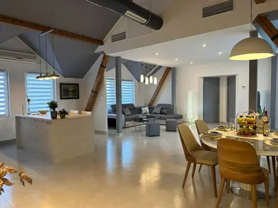 a kitchen and living room with a table and chairs at Iva Lux2 in Belgrade