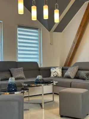 a living room with a couch and two tables at Iva Lux2 in Belgrade