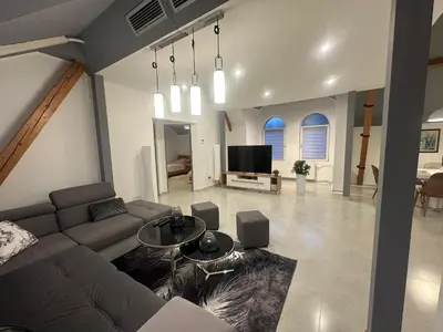 a living room with a couch and a tv at Iva Lux2 in Belgrade