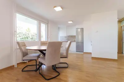 a kitchen and dining room with a table and chairs at Premium STAN 70 in Fontana