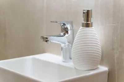a white vase sitting on a sink next to a faucet at Premium STAN 70 in Fontana