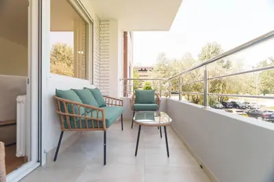 a balcony with two chairs and a table at Premium STAN 70 in Fontana