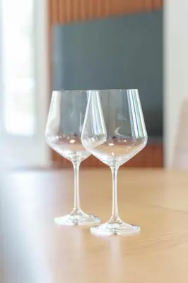 two wine glasses sitting on top of a table at Premium STAN 70 in Fontana