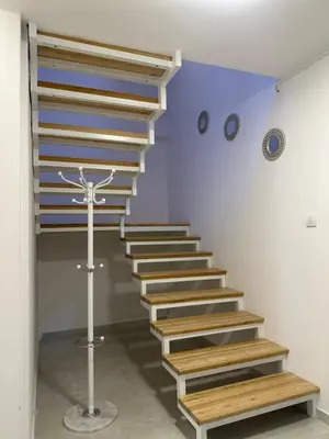 a set of stairs in a room with a clock on the wall at Iva Lux in Belgrade