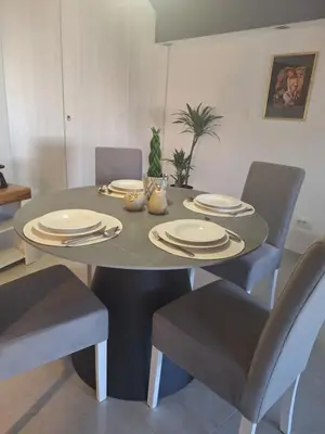 a dining room table with chairs and plates on it at Iva Lux in Belgrade