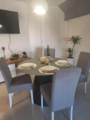 a dining room table with chairs and a dining room at Iva Lux in Belgrade