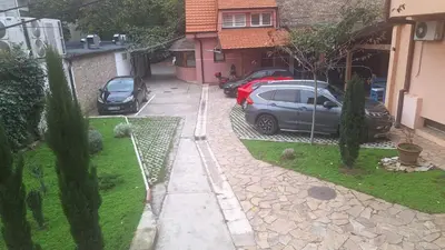 two cars parked in the driveway of a house at Iva Lux in Belgrade
