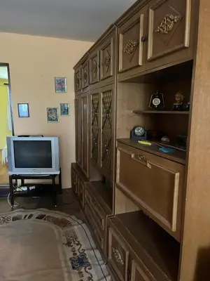 a living room with a television and a large wooden cabinet at Vikendica Mali Pozarevac