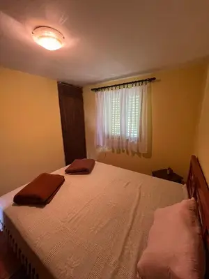 a bedroom with a bed with two towels on it at Vikendica Mali Pozarevac