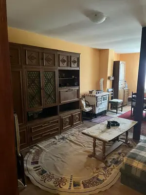 a living room with a table in the middle of a room at Vikendica Mali Pozarevac