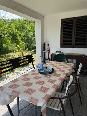 a table and chairs sitting on a patio at Vikendica Mali Pozarevac