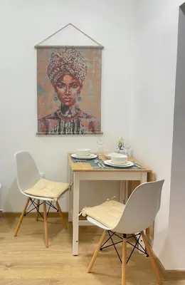 a table with two chairs and a painting on the wall at Mignon - Belgrade's Secret in Belgrade