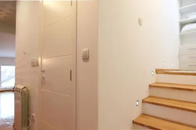a room with stairs and a closet with white cabinets at Purple and Green in Belgrade