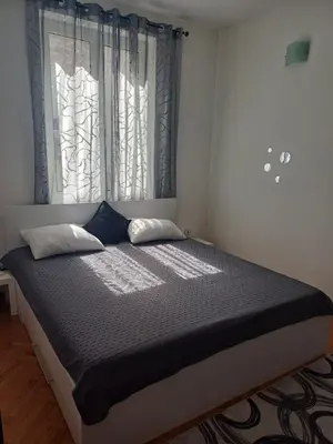 a bed in a room with two pillows and a window at Glorry L in Belgrade