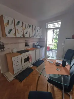 a kitchen with a table and a table and a dining room at Glorry L in Belgrade
