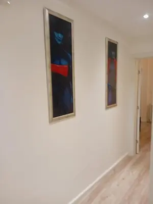 two paintings on a wall in a room at Senjak residence, apartment near Belgrade waterfront in Belgrade