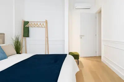 a bedroom with a bed with a blue blanket at BW Riverside in Belgrade