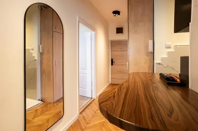a room with a wooden table and a mirror at MONE 2 bedroom apartment in Belgrade