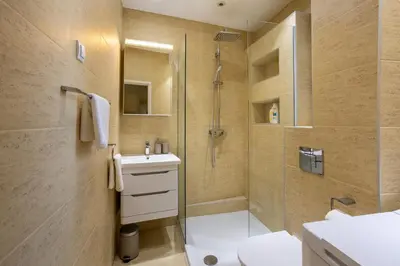 a bathroom with a shower and a toilet and a sink at MONE 2 bedroom apartment in Belgrade