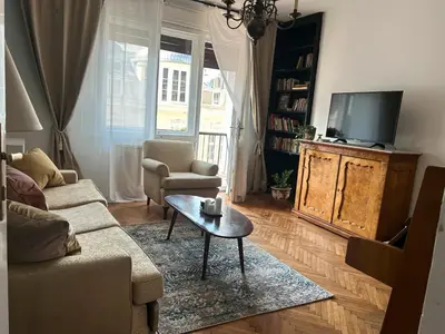 a living room with a couch and a tv at Cozy aparts in the city heart in Belgrade
