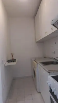 a white kitchen with a dishwasher and a sink at August in Belgrade