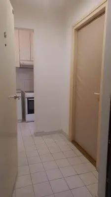 a kitchen with a door and a tile floor at August in Belgrade