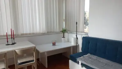 a living room with a blue couch and a table at August in Belgrade
