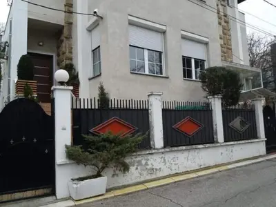 a house with a black fence and a gate at August in Belgrade