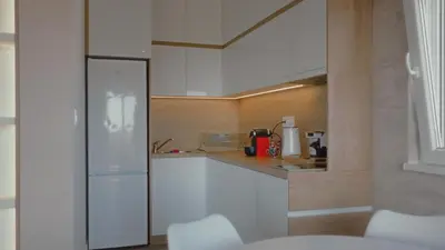 a kitchen with white cabinets and a counter top at Avalska Bajka in Ripanj