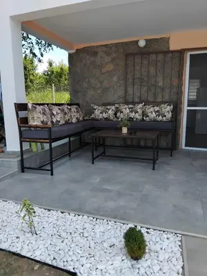 a couch and a table on a patio at Vila Aleksandar in Krčedin