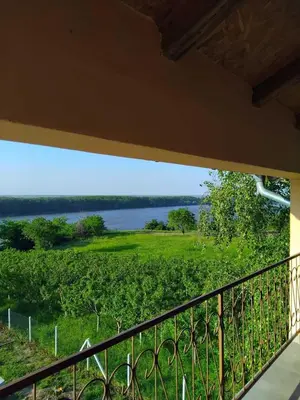a balcony with a view of a lake at Vila Aleksandar in Krčedin