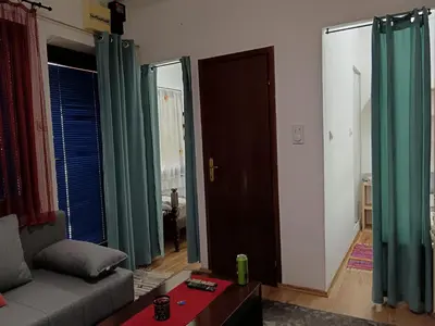 a living room with green curtains and a couch at Beograd-Zvezdara in Belgrade