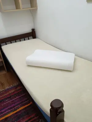 a bed in a room with a white mattress at Beograd-Zvezdara in Belgrade