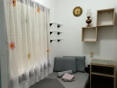 a room with a chair and a window with white shutters at Beograd-Zvezdara in Belgrade