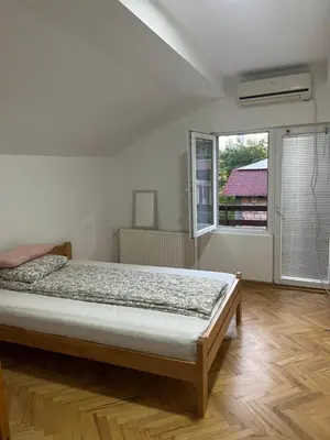 a bedroom with a bed and a large window at Aliyah Hostel in Belgrade
