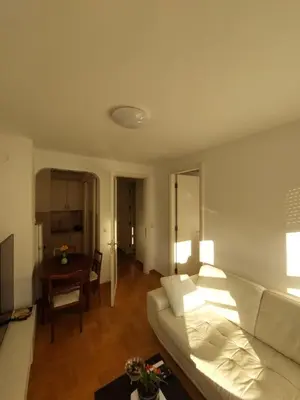 a living room with a white couch and a table at DELTA CITY Apartment in Novi Beograd