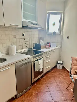 a kitchen with a sink and a stove top oven at Apartment Perfetto in Belgrade