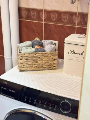 a basket of towels sitting on top of a washing machine at Apartment Perfetto in Belgrade