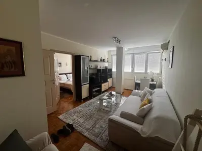 a living room with a couch and a table at Apartment Perfetto in Belgrade