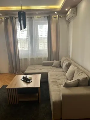 a living room with a couch and a coffee table at Centar stan na dan Ub in Ub