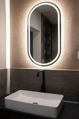 a bathroom with a sink and a mirror at 1922 Downtown Apartments in Belgrade