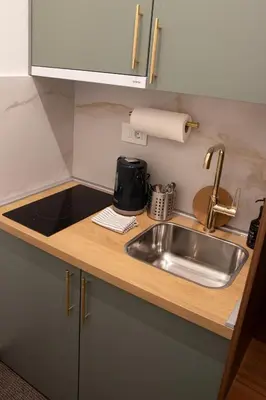 a kitchen counter with a sink and a coffee maker at 1922 Downtown Apartments in Belgrade