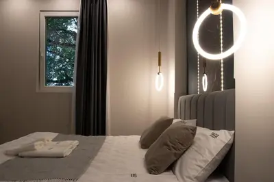 a bedroom with a bed with pillows and a window at 1922 Downtown Apartments in Belgrade