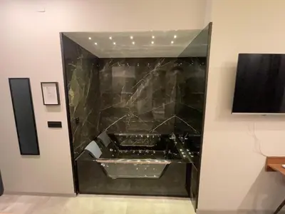 a bathroom with a black marble wall at 1922 Downtown Apartments in Belgrade