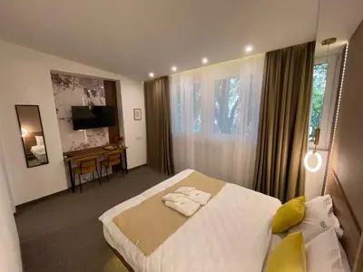 a bedroom with a bed and a desk in it at 1922 Downtown Apartments in Belgrade