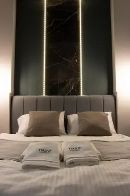 a bed with two white towels on top of it at 1922 Downtown Apartments in Belgrade